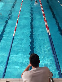 High angle view of girl standing in swimming pool