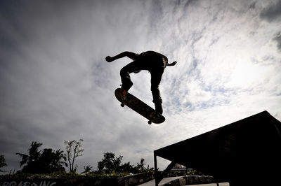 Low angle view of man skateboarding at park