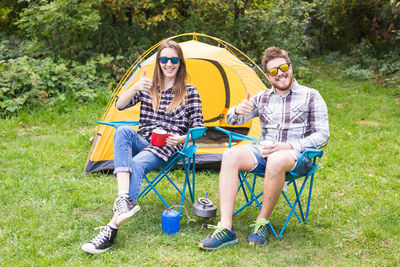 Young couple sitting in tent