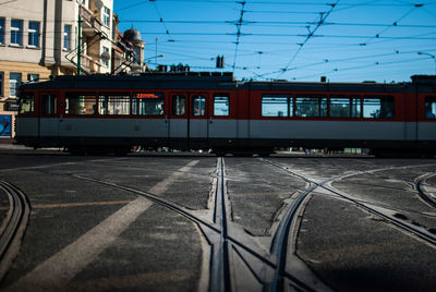 Tram on track against blue sky