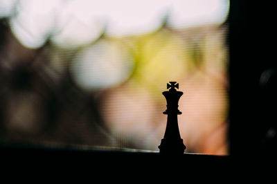 Close-up of silhouette statue against sky