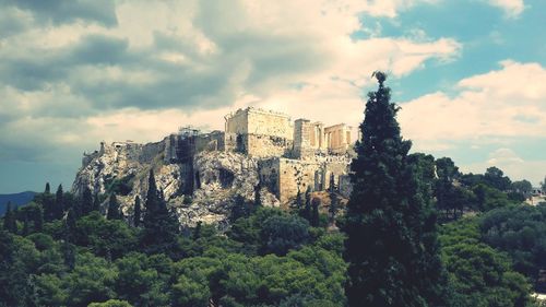 Behind trees the most historical place in greece, the acropolis of athens. 