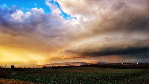 Scenic view of dramatic sky over landscape