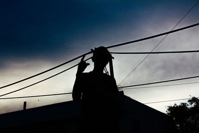 Low angle view of silhouette person against sky