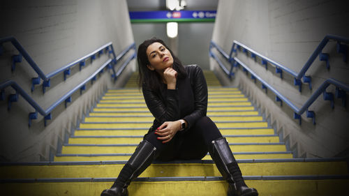 Portrait of woman sitting on stairs