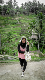 Portrait of man standing against trees