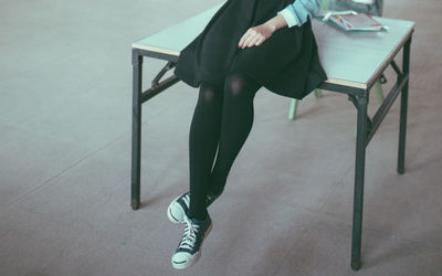 Low section of woman sitting on chair