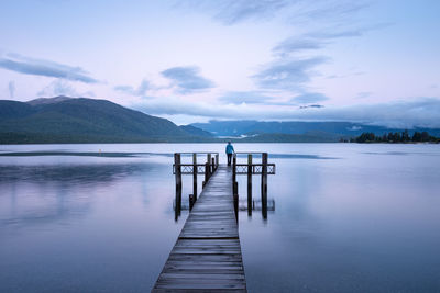 Pier over lake against sky