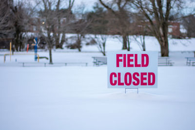 Information sign on snow covered field