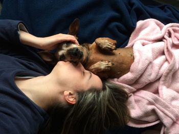 Man and dog lying on bed