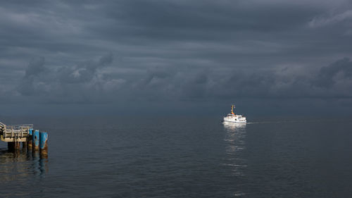 Boat sailing in sea against sky