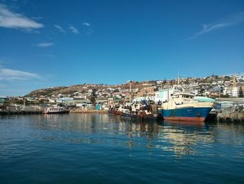 Boats in harbor with buildings in background