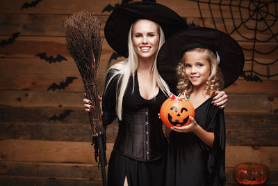Portrait of mother and daughter wearing halloween costume