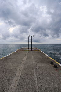 Pier over sea against sky