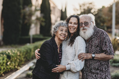 Portrait of active senior married couple and adult daughter smiling