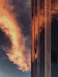 Low angle view of modern building against sky during sunset