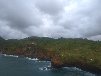 Scenic view of sea and mountains against sky