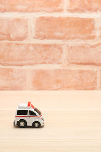 Close-up of toy car on table against wall