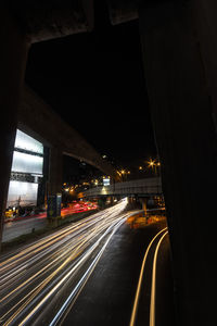 Light trails on road in city at night