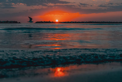 View of a beach with a sunrise in the background