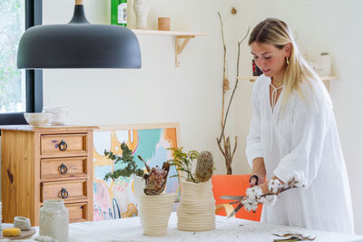 Portrait of the female florist working at her home studio