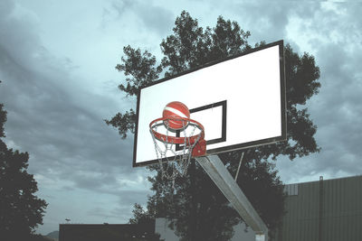 Low angle view of road sign against sky