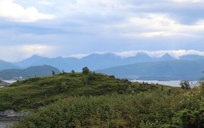 Scenic view of landscape and mountains against sky