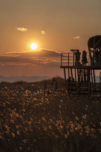 Scenic view of field against sky during sunset