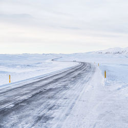 Snow covered landscape against sky