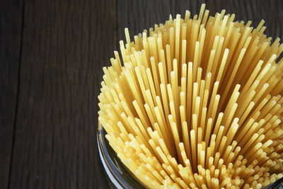 Close-up of spaghetti in jar on table