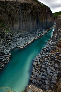 Scenic view of turquoise river in basaltic canyon