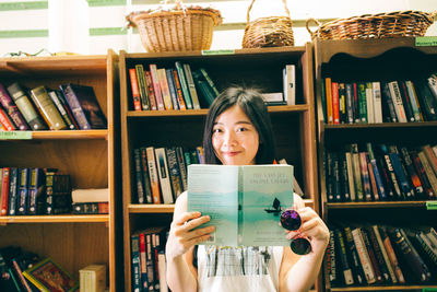 Portrait of young woman reading book