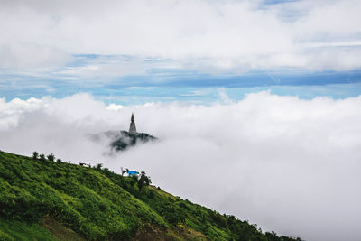 Scenic view of mountain against cloudy sky