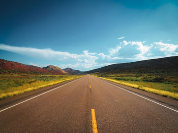 Empty road along countryside landscape