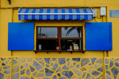 Yellow windows on wall of building