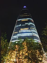 Low angle view of skyscrapers lit up at night