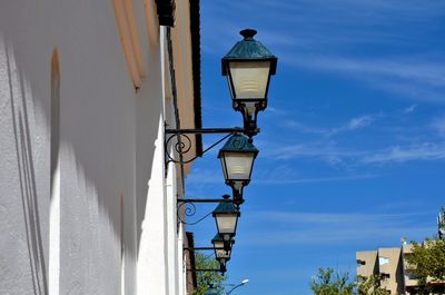 Low angle view of lamp post against blue sky