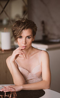 Portrait of a beautiful brown-eyed girl with a short haircut and makeup. girl in underwear