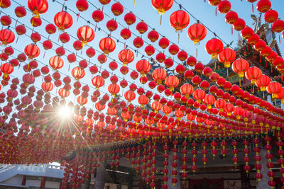 Low angle view of lanterns hanging against sky