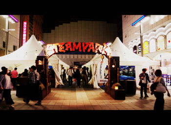 People at market in city at night