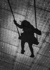 Shadow of man walking on footpath
