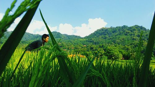 Man in field against sky