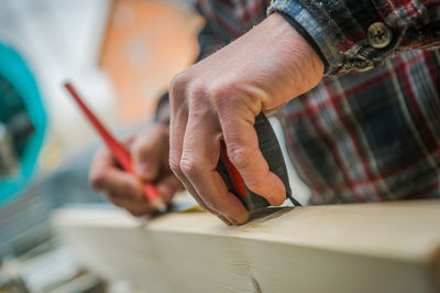 Midsection of man working at workshop