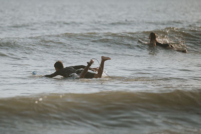 Men in water at beach