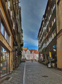 Empty road amidst buildings in town