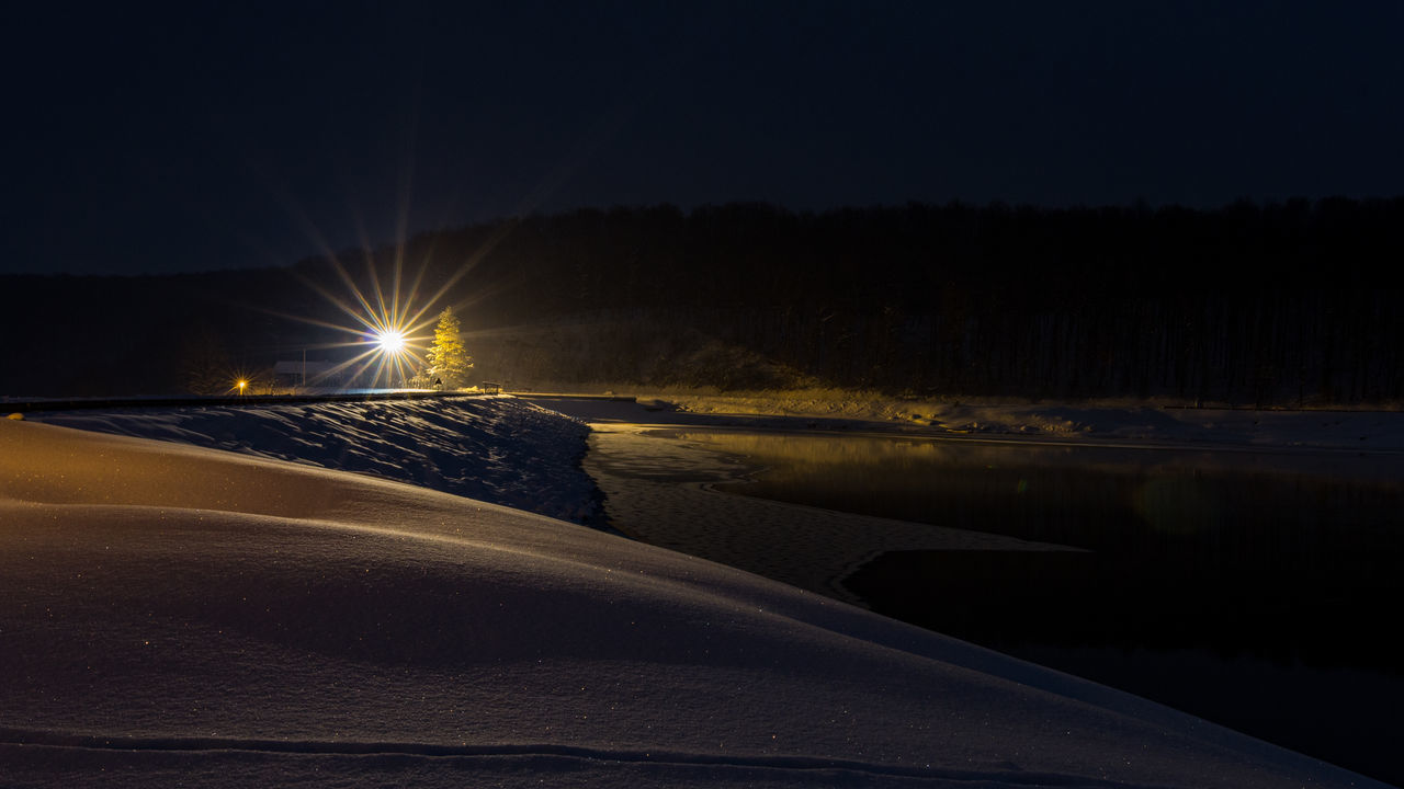 ILLUMINATED ROAD AT NIGHT