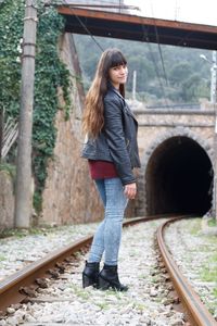 Full length of woman standing on railroad track