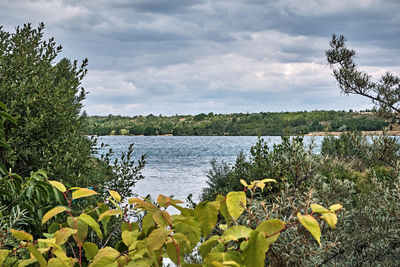 Scenic view of lake against cloudy sky