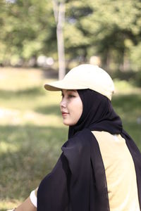 Portrait of a teenage girl standing on field