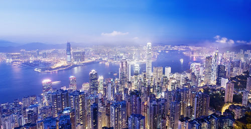 High angle view of illuminated city buildings against sky